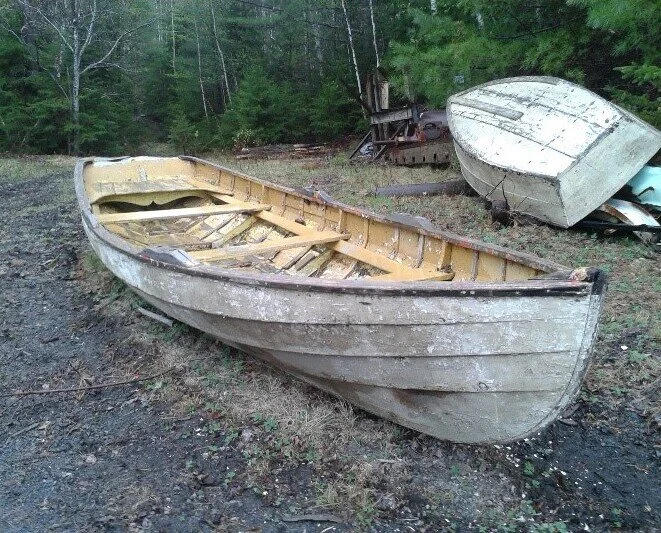 The original 1950s Bruhm family river skiff resting on grass