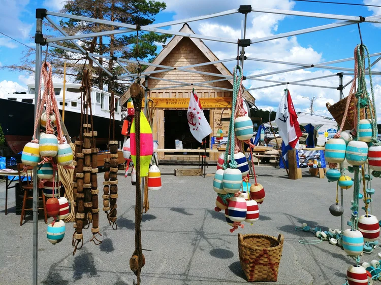 Heritage Day event tent in front of the shed, hung with colourful fishing buoys, ropes and floats