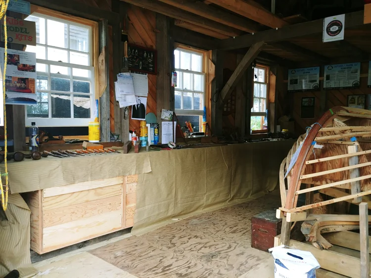 Workbench along the shed wall laid out with hand tools and chisels