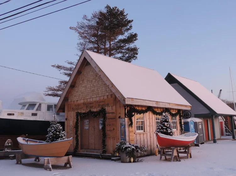The boatbuilding shed at dusk during the Father Christmas Festival serving as the 'Reindeer Flyer Station'